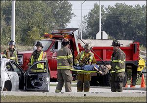 Authorities respond to ‘injured’ people in a  simulated drill on the Ohio Turnpike during a Lucas and northern Wood county mass casualty incident response plan exercise on Wednesday.