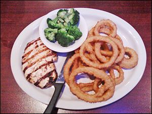Grilled chicken breast with broccoli and onion rings.
