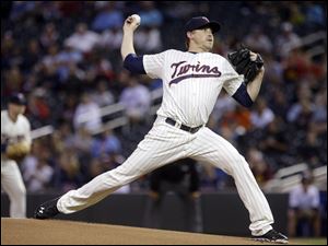 Minnesota Twins pitcher Kevin Correia throws against the Detroit Tigers during the first inning Wednesday night.