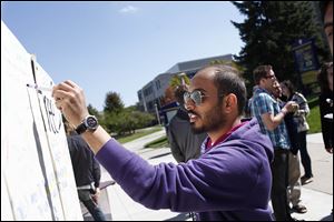 University of Toledo student Meshaal Alibrahin signs a 