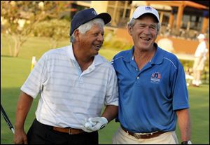 Lee Trevino and former president George W. Bush laugh prior to the Bush Center Warrior Open golf pro-am tournament for wounded veterans at the Las Colinas Country Club in Irving, Texas. 