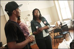 Naquasia LeGrand talks with other fast-food workers in New York. Despite her initial caution toward unionizing, Ms. LeGrand has become an energetic  organizer telling workers they have little to lose and much to gain.