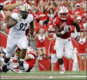 Wisconsin's James White breaks away from Purdue's Ryan Watson for a 70-yard touchdown run last weekend. White is the active career rushing leader in the FBS.