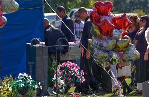 The casket of Elaina Steinfurth, 18 months, is carried to Lake Township Cemetery for burial. The girl’s remains were found in a garage on Sept. 5, some three months after she disappeared.