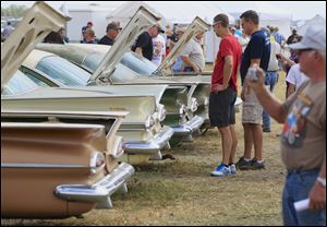 Car buffs survey Chevrolet vehicles during a preview for an auction of vintage cars and trucks from the former Lambrecht Chevrolet dealership.