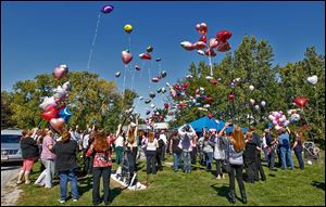 Mourners of Elaina Steinfurth release balloons at the Lake Township Cemetery in Millbury, where the toddler was buried on Saturday. Elaina went missing on June 2.