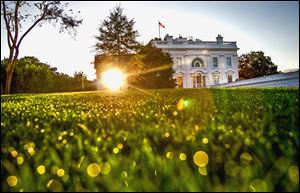 The sun rises behind the White House on Sunday morning as the debate continues over implementation of the nation's health-care law requiring insurance exchanges. 