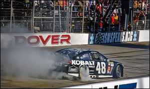 Jimmie Johnson performs a burnout after he won Sunday's race at Dover International Speedway. The victory moved into second place in the Chase.