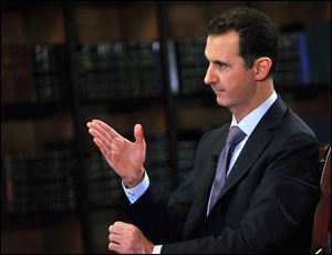 Assad says his government will abide by last week's U.N. resolution calling for the country's chemical weapons program to be dismantled and destroyed.