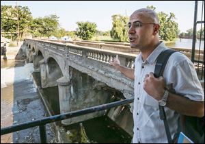 Assistant Professor Hisyar Ozsoy of the  University of Michigan Flint stands by the Hamilton Dam in downtown Flint. The dam is one of the worst-rated in the state and is in need of immediate repairs to maintain its structural integrity.