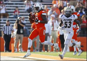 Bowling Green State University player Travis Greene (13) scores a touchdown against Akron University during the fourth quarter Saturday.