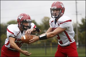  Wauseon senior Ty Suntken, who has run for 522 yards, hands off the ball to senior Axel Bueter, who has 770 yards rushing.