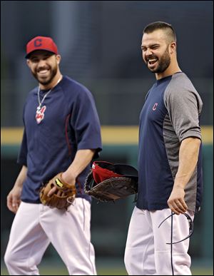 Cleveland Indians first baseman Nick Swisher, right, and second baseman Jason Kipnis keep things loose during a workout at Progressive Field. The Indians host Tampa Bay in a wild-card game.