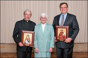 Sister Mary Jon Wagner, Congregational Minister for the Sisters of St. Francis of Sylvania, center poses for a photo during the Sylvania Franciscan Gala with awardees Father Robert Wilhelm, recipient of the 2013 St. Clare Award, left, and Joseph Nachtrab, president of Northaven Development Group and recipient of the 2013 St. Francis Award.