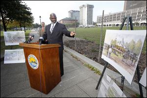 Toledo Mayor Mike Bell talks about the upcoming construction at Promenade Park during a news conference in the park Wednesday. The second phase of the project is expected to be completed by June, 2014.