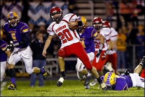 Wauseon's Axel Bueter dodges several Bryan defenders en route to a big gain for the 5-1 Indians.