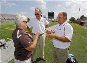 Steve Messenger, Operations and Events Coordinator at Bowling Green State University, right, speaks with BGSU marching band director Carol Hayward and television personality Jerry Anderson before the Falcons' home opener.