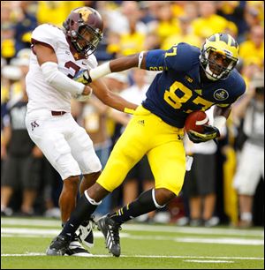 University of Michigan player Devin Funchess (87) breaks away from University of Minnesota player Martez Sabazz for a touchdown during the second quarter.