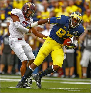 Michigan tight end Devin Funchess breaks away for a touchdown against Minnesota's Martez Sabazz.