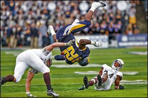 Toledo running back David Fluellen is knocked upside-down by Western Michigan linebacker Kyle Lark. Fluellen finished with 220 yards on 23 carries and scored four touchdowns.