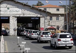 A convoy of inspectors from the Organization for the Prohibition of Chemical Weapons prepares cross into Syria at the Lebanese border crossing point of Masnaa, eastern Bekaa Valley, Lebanon. An advance group of 20 inspectors from a Netherlands-based chemical weapons watchdog arrived in Syria on Tuesday to begin their complex mission of finding, dismantling and ultimately destroying an estimated 1,000-ton chemical arsenal.