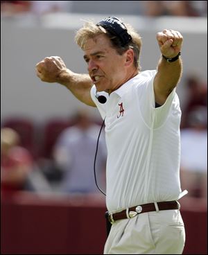 Alabama head coach Nick Saban signals to his a players during the second half Saturday in Tuscaloosa, Ala.