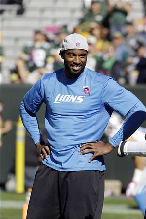 Lions receiver Calvin Johnson watches the Detroit-Green Bay game from the sidelines with a knee injury.