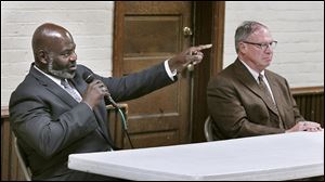Mike Bell, left, and D. Michael Collins debate Tuesday during a forum at Walbridge Park in South Toledo. Mayor Bell appeared to grow impatient at having to discuss the city’s 2010 deficit.
