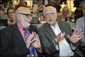 Belgian  physicist  Francois Englert, left, and British physicist Peter Higgs right, answer journalist's question about the scientific seminar to deliver the latest update in the search for the Higgs boson at the European Organization for Nuclear Research (CERN) in Meyrin near Geneva, Switzerland in July, 2012.