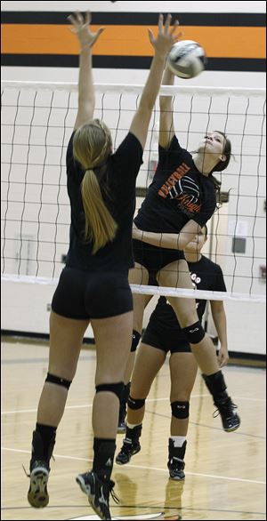 Otsego junior Abby Hesselschwardt spikes the ball against Morgan Smoyer in practice. Hesselschwardt leads the Knights with 250 kills this season.