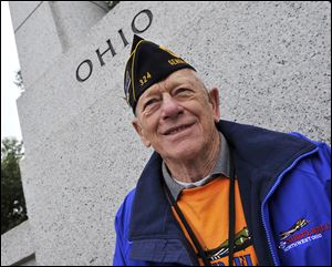 Honor Flight of Northwest Ohio member Ned Ammons  smiles under the Ohio section of the World War II Memorial on Wednesday in Washington.