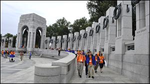 Members of the Honor Flight of Northwest tour the World War II Memorial on Wednesday in Washington. Park service rangers said they are allowing anyone to enter the park for First Amendment activities.