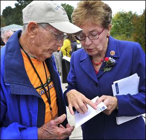 Ohio congressman Marcy Kaptur talked with Honor Flight of Northwest Ohio  member and Navy veteran Dwaine Betz at the World War II Memorial in Washington. Miss Kaptur was instrumental in getting the memorial built.