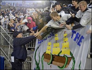 Penn State head coach Bill O' Brien, left, thanks fans in the student section of Beaver Stadium.