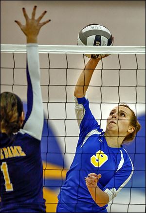 St. Ursula's Emily Lydey spikes the ball against Notre Dame's Alexa Saunders. Lydey finished with five kills in the three-game win.