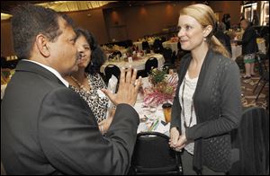 Abhay and Vandita Prasad speak to best-selling author and speaker Tanya Biank, right, during the fund-raiser for Sparrow's Nest at The Pinnacle.