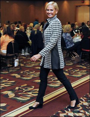 Model Cay Stout models an outfit during the fund-raiser for Sparrow’s Nest at The Pinnacle in Maumee. The event featured financial, health, and other experts, and a fashion show.