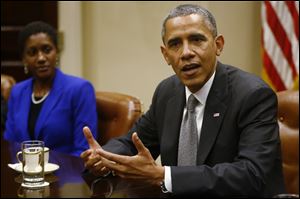 President Barack Obama, seated next to Hester Clark, president and chief executive officer of the Hester Group, speaks during a meeting with small business owners to talks about the government shutdown and debt ceiling, Friday in the Roosevelt Room at the White House in Washington.
