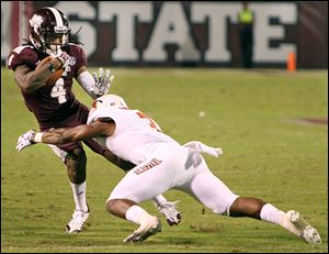 Mississippi State wide receiver Jameon Lewis, left, tries to dodge Bowling Green defensive back Brian Sutton in the second half on Saturday. Lewis finished with 34 receiving yards for the Bulldogs.