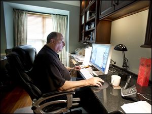 Graphic designer Tom Sadowski, 65, who delayed his retirement, works from home in Sterling, Va. Older Americans appear to have accepted the reality of a retirement that comes later in life and no longer represents a complete exit from the work force, a survey finds.