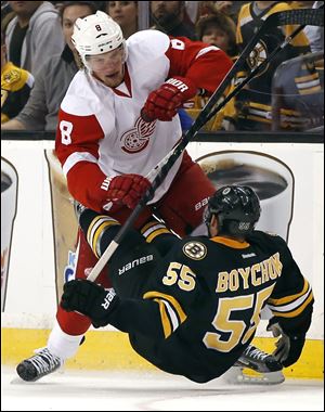 Detroit Red Wings left wing Justin Abdelkader (8) checks Boston Bruins defenseman Johnny Boychuk (55) to the ice during the Wings 3-2 win in Boston. 