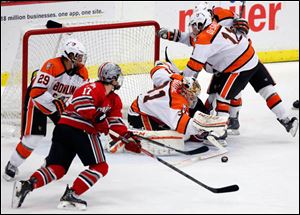 Bowling Green State University goalie Tommy Burke (32) blocks a shot against Ohio State.