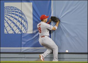 St. Louis Cardinals' Jon Jay can't come up with a ball hit by Los Angeles Dodgers' A.J. Ellis during the fifth inning.