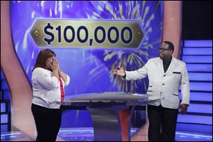 Tracey Launder of Rossford reacts with host Cedric 'The Entertainer' after winning $100,000 on 'Who Wants to be a Millionaire.'