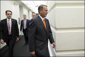 Speaker of the House Rep. John Boehner, a Republican from Ohio, walks to a meeting with House Republicans to discuss the Senate measure on the government shutdown and debt ceiling. 