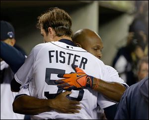 Detroit Tigers' Doug Fister is hugged by Torii Hunter after the sixth inning.