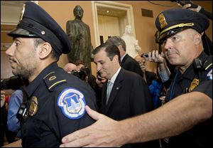 Sen. Ted Cruz (R., Texas) walks with security on Capitol Hill in Washington. A bipartisan deal prevented a possible federal default and ended the partial government shutdown after 16 days.