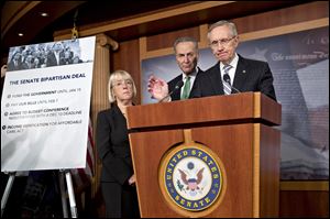 Senate Majority Leader Harry Reid (D., Nev.) speaks with reporters after voting on a measure to avert a threat-ened Treasury default and reopen the government after a partial, 16-day shutdown at the Capitol in Washing-ton as Sen. Patty Murray (D., Wash.) and Sen. Chuck Schumer (D., N.Y.) listen.