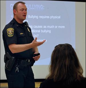 Sylvania police Sgt. Justin Music speaks to parents at Sylvan Elementary School about cyber bullying.