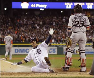 Detroit's Jose Iglesias scores on a double by Torii Hunter in the second inning of Game 4 of the American League Championship Series.